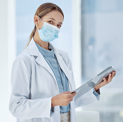 Image showing Doctor with covid face mask and a checklist for compliance, risk management and medical insurance. Portrait of a healthcare woman expert with corona virus innovation planning in a hospital or clinic