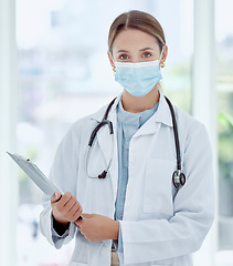 Image showing Medical doctor in covid hospital portrait, health safety compliance and healthcare professional woman with face mask. Expert consultation, clinical medicine work and clipboard examine virus results