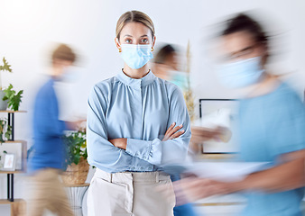 Image showing Portrait of business woman in office during covid and a blur of people in the office. Business people, compliance and wearing face mask for safety. Female leader working in busy fast pace workplace