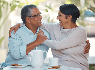 Image showing Senior couple laughing, drinking coffee and bonding in backyard cafe together, relax and cheerful outdoors. Elderly man and woman enjoying retirement and their relationship, sharing a joke and snack