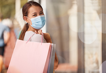 Image showing Shopping, medical mask or portrait of woman with shopping bags, smile or happy sale luxury designer clothes. Covid, rich customer or Asian girl with retail discount, fashion or store sales in street