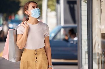 Image showing Covid shopping, city fashion and woman with face mask for security from virus, in the street of shopping mall and with retail bag. Sick girl customer with covid 19 being safe while in the urban town