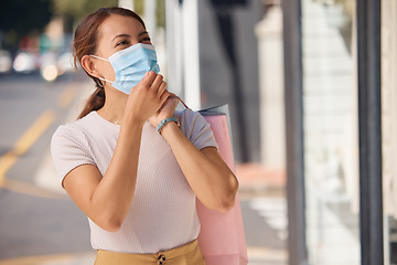 Image showing Woman, shopping and face mask for covid with retail bags outdoor in a urban city. Rich customer, consumer spending and wealthy female person in street outside a store buying luxury fashion