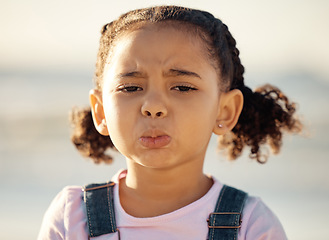 Image showing Portrait, sad and face of an unhappy little girl feeling lonely or upset against a blurred background. Closeup of an emotional African female child with depressed facial expression for end of summer