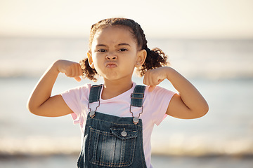 Image showing Beach, summer and little girl pulling funny face and flexing on holiday in Mexico. Strong, courage and child at ocean on vacation in Cancun. Waves, sea and sand, healthy kid in nature on school break