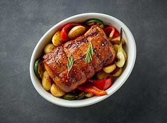 Image showing whole roast pork and vegetables