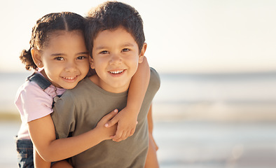 Image showing Happy, smile and portrait of siblings at the beach hugging and playing while on summer vacation. Happiness, ocean and brother giving his sister a piggyback ride while on a seaside family holiday.