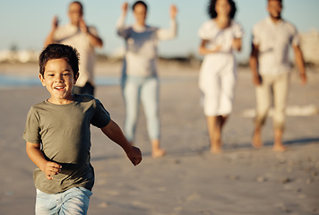 Image showing Boy, running and beach with family, happy and cheerful while walking in the sand. Young male child by ocean, run on shore in summer, parents and grandparents have joyful time together in background
