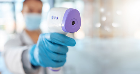 Image showing Covid, nurse hand and health thermometer scan check at a hospital, healthcare or clinic from a doctor. Woman working with medical temperature measure to see fever for disease, dengue fever or corona