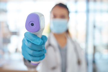 Image showing Hand, woman doctor and covid test thermometer laser gun for medical exam, check or covid 19 scan at vaccine center. Healthcare nurse, mask and glove for corona virus safety and protection at clinic