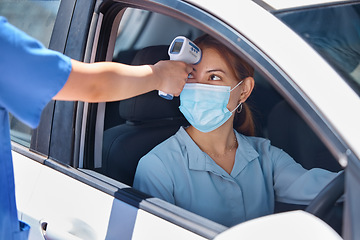 Image showing Car, drive thru covid test and thermometer with nurse and patient. Young woman in vehicle, wearing a mask and medical care worker doing fever screening. Masks, coronavirus and testing on site