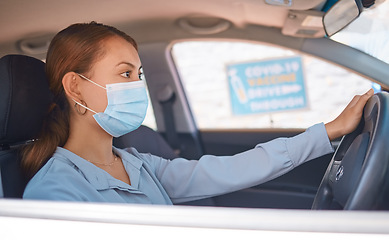 Image showing Covid vaccine, car drive and woman with face mask for safety, compliance and healthcare at an outdoor clinic or hospital. Person in vehicle at covid 19 drive thru for corona virus medical vaccination