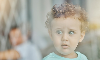 Image showing Baby, eyes and safety at window curious with wonder on face in home, toddler and looking in distance alone. Child or boy thinking with thoughtful expression, for danger and left unattended in house