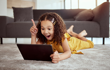 Image showing Creative thinking, tablet learning and girl streaming education video on internet, planning idea with tech and excited about web app on living room floor. Kid with smile and solution to game online