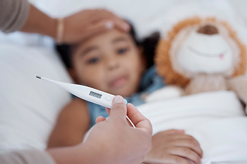 Image showing A child in bed with covid, a fever and thermometer showing temperature. Mother with sick kid with hand on head to check if it is hot or cold. Ill with flu, healthcare and medical care in family home