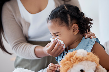 Image showing Mother clean sick child nose with tissue, playing with toy or teddy bear in bedroom at family home. Teacher at kindergarten use toilet paper, to help clean young girl face after sneeze or runny nose