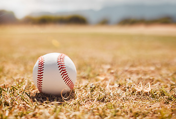 Image showing Baseball, sports ball and empty sport field on grass outdoor training pitch. White ball on the ground for exercise, cardio training and fitness workout of player and athlete team game in autumn