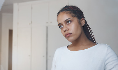 Image showing Sad, thoughtful and depressed woman in her home feeling alone and isolated. Mock up for depression, sadness and mental health issues. Thinking, worried and upset young girl with problems in her room