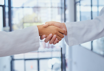 Image showing Doctors meeting, shaking hands and partner at hospital with lab coats. Scientist or doctor agree on medical business, support and cooperate together with handshake to show collaboration and teamwork