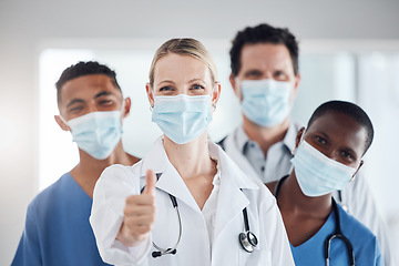 Image showing Thumbs up, covid and doctors with nurses with mask at hospital or clinic. Portrait, health goal or approval hands after successful surgery, okay for success or yes welcome to the team and thank you.