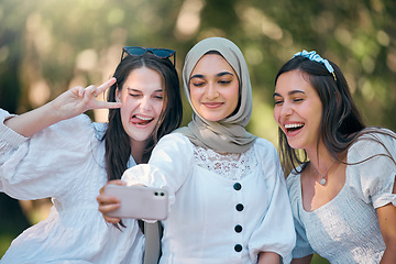 Image showing Selfie, phone and friends in nature park relax, bond or enjoy outdoor quality time together on spring day. Smile, goofy or fun group of people, girl or diversity women post to online social media app