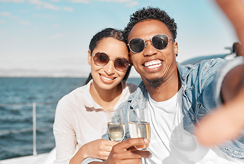 Image showing Yacht, luxury and sea travel couple with champagne smiling on their anniversary in summer. Happy, love smile and ocean selfie of a woman and man on holiday with happiness drinking alcohol together