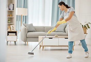 Image showing Cleaning, asian girl and sweeping floor with broom for home interior spring clean tidy habit. Housekeeping woman busy with housework in apartment living room for good hygiene lifestyle in house.