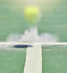 Image showing Tennis, sport and training with a ball on a court bouncing during a game to score a point or winner. Sports, scoring and boundary with a match playing on a field with chalk and artificial grass