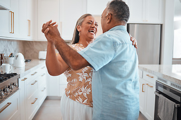 Image showing Happy senior couple, dance and laughing in joyful happiness for relationship bonding in the kitchen at home. Elderly man and woman with smile dancing together for romantic moment in love and care