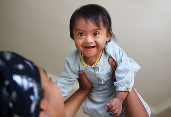 Image showing Happy, down syndrome baby and child mom care of a woman holding a kid with a disability at a house. Happiness and smile of a young toddler special needs face from India in a home with a mother