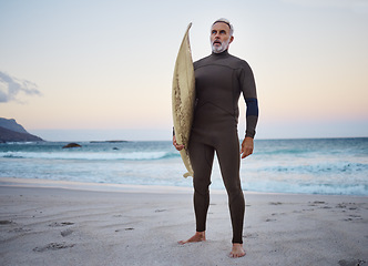 Image showing Surfing, beach and senior man on vacation for surf training in nature by ocean in Australia. Travel, surfboard and elderly surfer in retirement on summer holiday to exercise, relax and enjoy the sea.