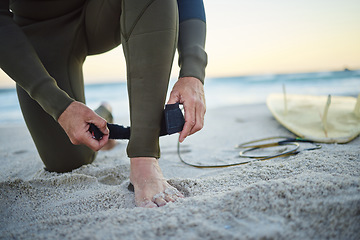 Image showing Foot, with surfboard and leash on sand prepare to enter sea, on beach and to relax on holiday, vacation and wet suit. Surfing, healthy man and ready to surf ocean for wellness and health on seaside.