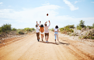 Image showing Summer, adventure and friends walking on dirt road in the country, throwing ball in air. Travel, freedom and young group of men and women on holiday together to explore nature, vacation and blue sky