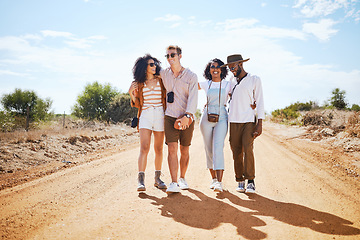 Image showing Travel, adventure and friends walk on road path together to explore the Arizona desert in the USA. Bush holiday adventure with diverse friendship and couple group enjoying summer sunshine break.