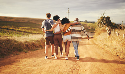 Image showing Friends, hug and vacation in the countryside for holiday travel enjoying time together in nature. People in friendship support, care and love hugging on a dirt road walking in South Africa