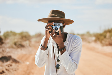 Image showing Travel, photographer and man in a desert in Australia, taking photograph of nature, beauty and earth. Countryside, photography and black man on discovery journey, traveling and enjoying the view