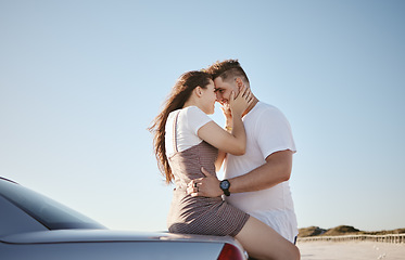Image showing Love, relax and couple embrace at car for intimate driving break together in Los Angeles, USA. Young, happy and caring people enjoy summer sunshine with romantic touch while leaning on vehicle.