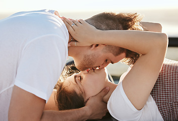 Image showing Couple, love and kiss with a man and woman on a road trip for their honeymoon, vacation or travel. Romance, kissing and together with a male and female enjoying a date together during summer