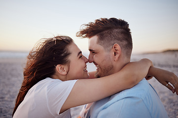 Image showing Couple with love, happy and together on a beach during vacation in hawaii. Man and woman hug affection anniversary, bonding and relax outdoor in summer. Romantic getaway for two at the sea in sunset