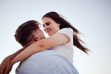Image showing Happy, couple and love hug for real joy in happiness for bonding relationship and travel in the outdoors. Man lifting woman in loving embrace for romance with smile on summer vacation together