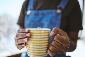 Image showing Hands, coffee shop and relax with a black woman holding a cup to drink while resting or taking a break indoors. Cafe, tea or diner with the hand of a female in a restaurant on a weekend morning