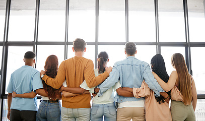 Image showing Trust, community and business team with vision looking out of a window, rear view embrace in support of future startup mission. Partnership, collaboration and goal with employee group in solidarity