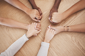 Image showing Diversity, people holding hands and support for trust and relationship for unity, commitment and community. Group of diverse hand in teamwork collaboration and multiracial respect on a wooden table