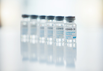 Image showing Healthcare, medicine and covid vaccine bottle, stock and product in a hospital office. Healthcare with a virus cure, wellness or corona drug in a medical research clinic for safety from covid 19