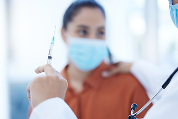 Image showing Medical doctor giving covid vaccine to woman in consultation room wearing face mask. Medicine, healthcare and patient with immunity injection at hospital for covid 19 virus prevention and treatment