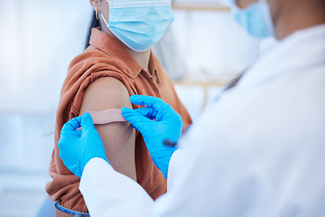 Image showing Medical doctor or nurse with plaster for covid vaccine injection on arm. Zoom in woman patient with mask treatment for disease or flu shot while working in hospital or clinic with healthcare expert