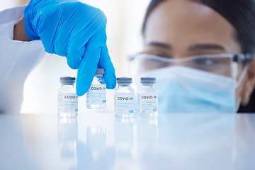 Image showing Covid, vaccine and hands of doctor with bottle of liquid while working at a hospital. Medical nurse, worker and surgeon with healthcare medicine for safety from virus with a face mask at a clinic