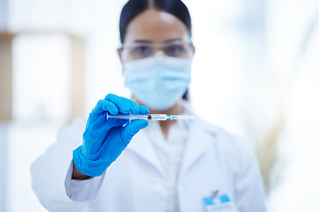 Image showing Doctor, covid 19 and vaccine in hospital, lab or clinic for safety, health and wellness against virus. Woman, healthcare and ppe at work in medical facility with vaccination for coronavirus in Canada