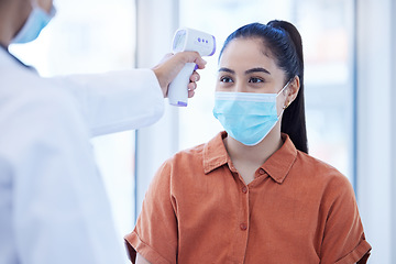 Image showing Covid doctor check woman thermometer for fever, sickness and flu test analysis in clinical surgery. Face mask patient, forehead laser and healthcare consulting corona virus safety in medical hospital