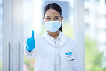 Image showing Doctor, mask and thumbs up at work in hospital, clinic or office for success in healthcare. Medic, woman and professional in medical ppe do hand sign to agree in health, medicine and community safety